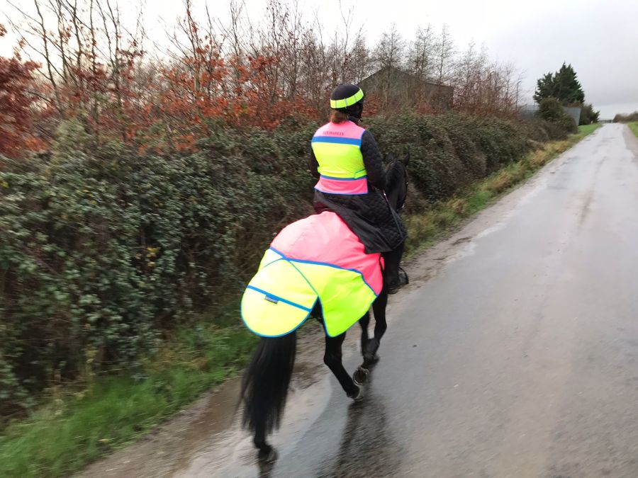 Out hacking wearing the Covalliero Long Quilted Coat under high vis clothing