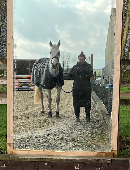 Leading a horse wearing the Covalliero Long Quilted Coat