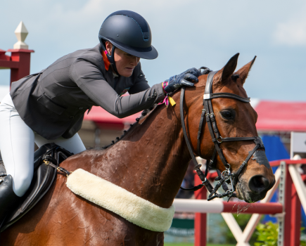 Bubby Upton is pictured at Badminton Horse Trials giving her horse Cola a pat and looking emotional