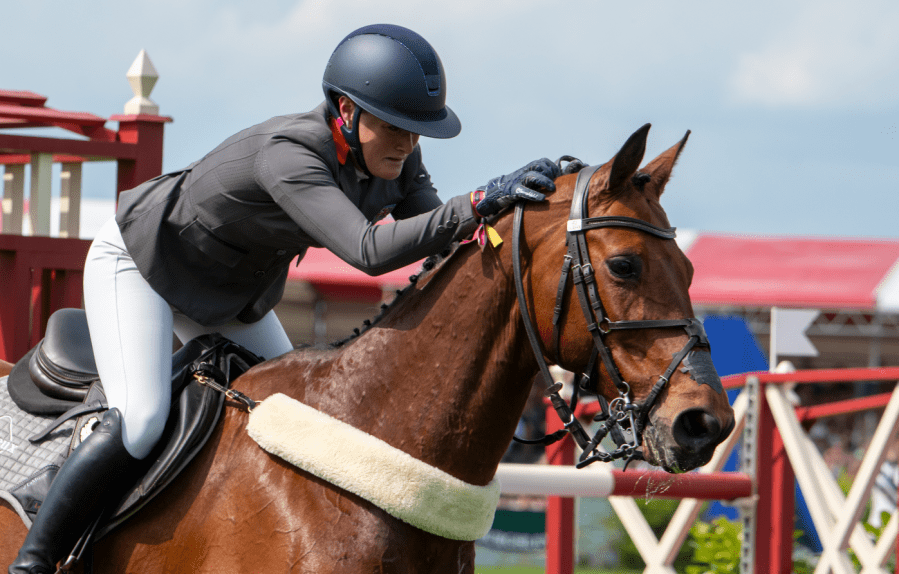 Bubby Upton is pictured at Badminton Horse Trials giving her horse Cola a pat and looking emotional