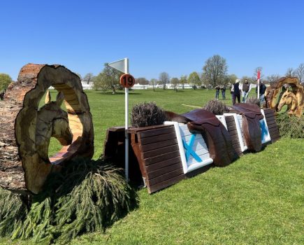 Pictured is the Voltaire Design cross-country fence with saddles on the top at the 2024 Grassroots Championships at Badminton Horse Trials
