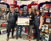 Emma Webb receives cheque from John Whitaker at Your Horse Live