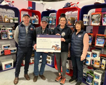 Emma Webb receives cheque from John Whitaker at Your Horse Live