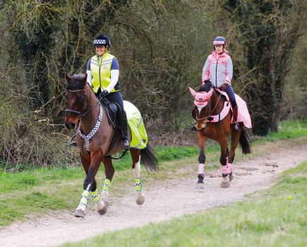 Pictured are two riders out hacking a horse or trail riding wearing high vis gear